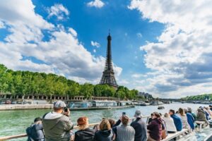 people sightseeing on a boat overlooking the eiffel tower on a day cruise tour