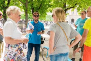 Tourists and a tour guide enjoying the shade of trees