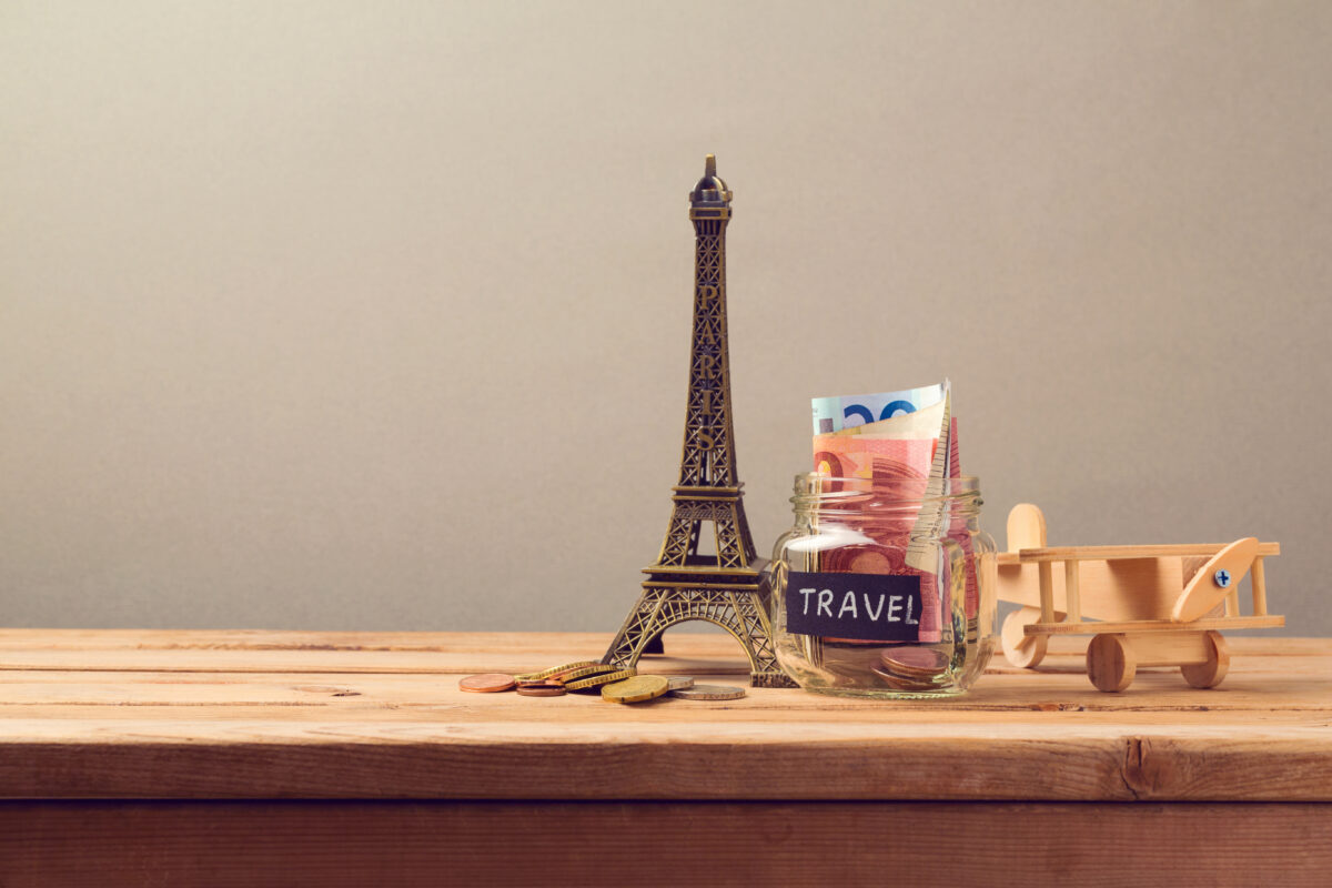 Travel to Paris, France concept with Eiffel Tower souvenir and wooden airplane toy. 