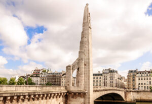 Pont de la Tournelle in Paris, historic bridge with spire over river.