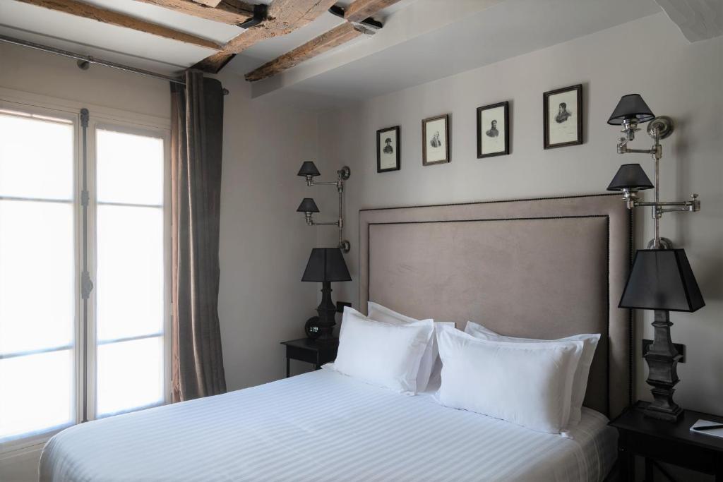 Rooms at Hotel Saint-Louis en L'Isle - Notre-Dame offer a harmonious blend of comfort and Parisian charm.