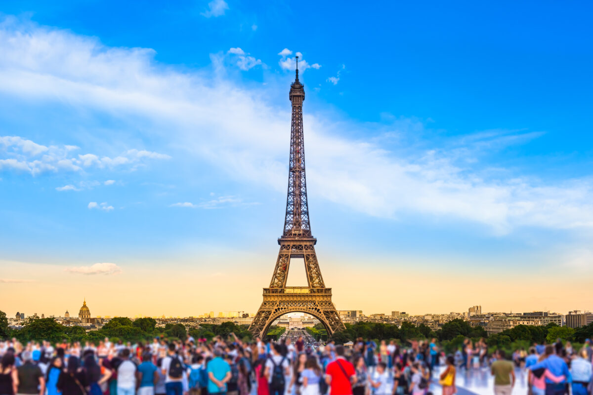 Tourists crowd in front of Eiffel Tower, Paris, France