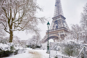 Scenic view to the Eiffel tower on a day with heavy snow. Unusual weather conditions in Paris