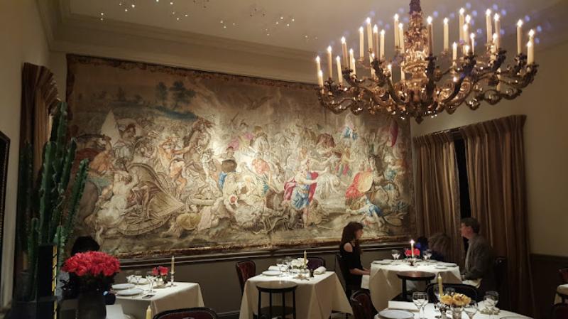 Couple dining at L'Ambroisie restaurant in Paris, France