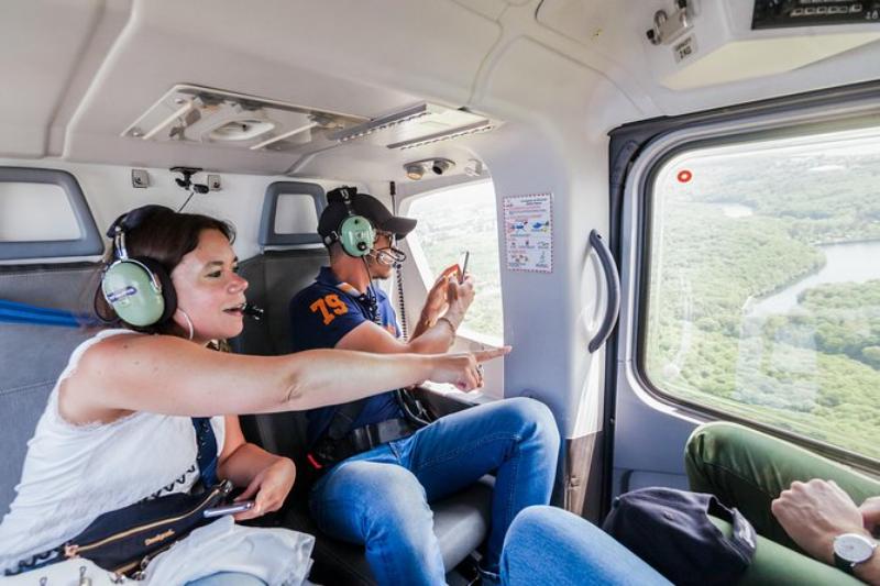 Tourists checking out view outside helicopter