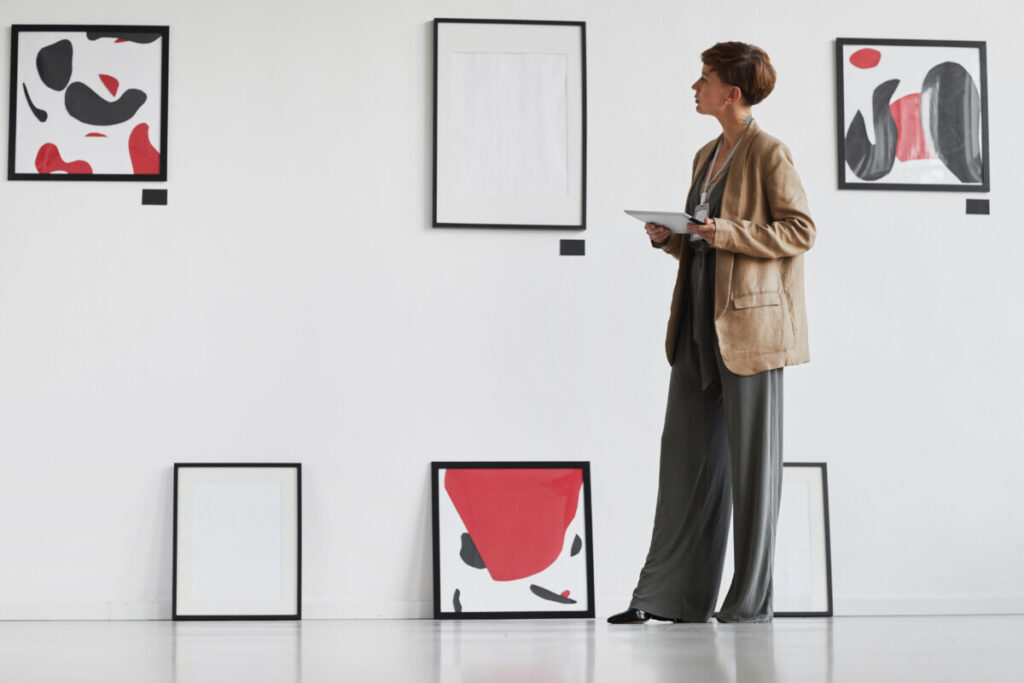 Art gallery worker checking the displayed art exhibit