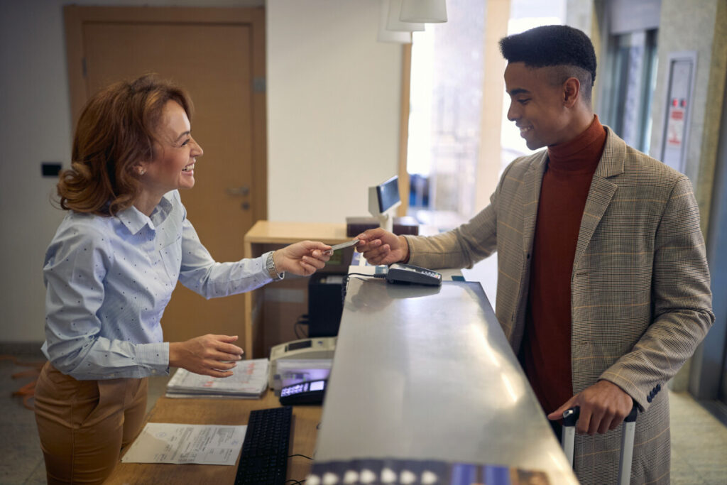 Smiling female receptionist welcoming a traveler