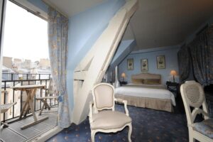 The featured bedroom at Hôtel des Ducs D'Anjou is a luxurious retreat designed to provide guests with a comfortable and memorable stay in the heart of Paris.