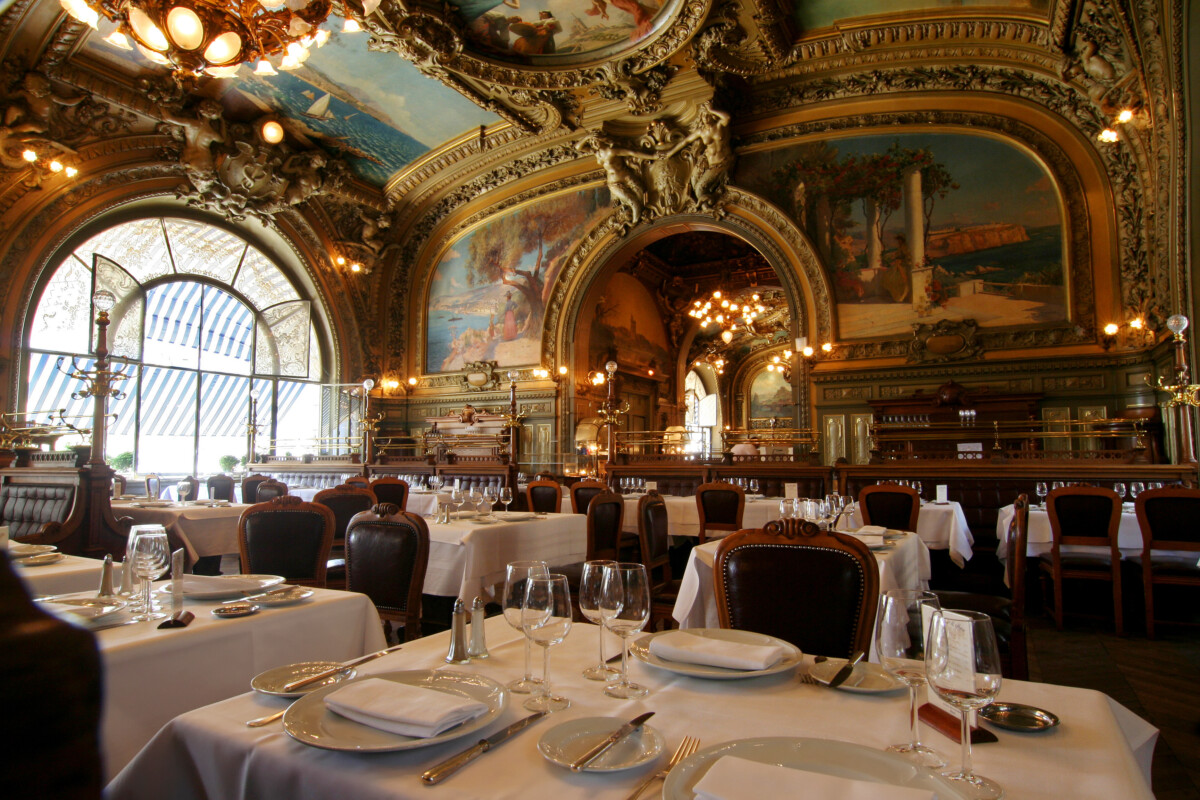 Dining tables and interior of the Le Train Bleu Restaurant in Paris, France