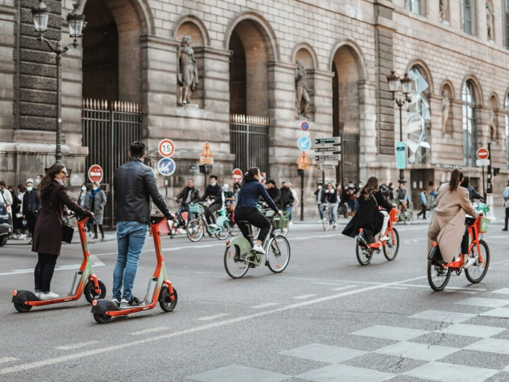 Group of people riding bicycles and scooters in Paris, France