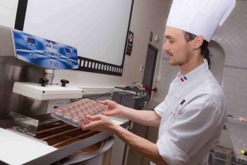 Man doing a chocolate  demonstration in Paris Gourmet Chocolate Museum