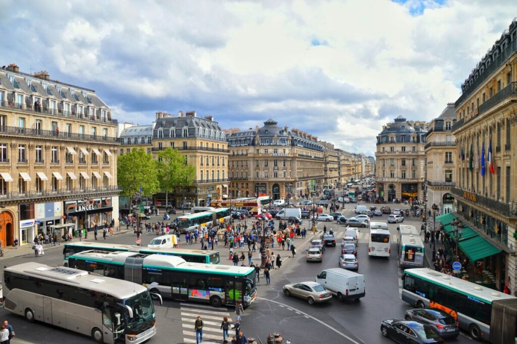 Busy street with several vehicles in traffic in Paris, France