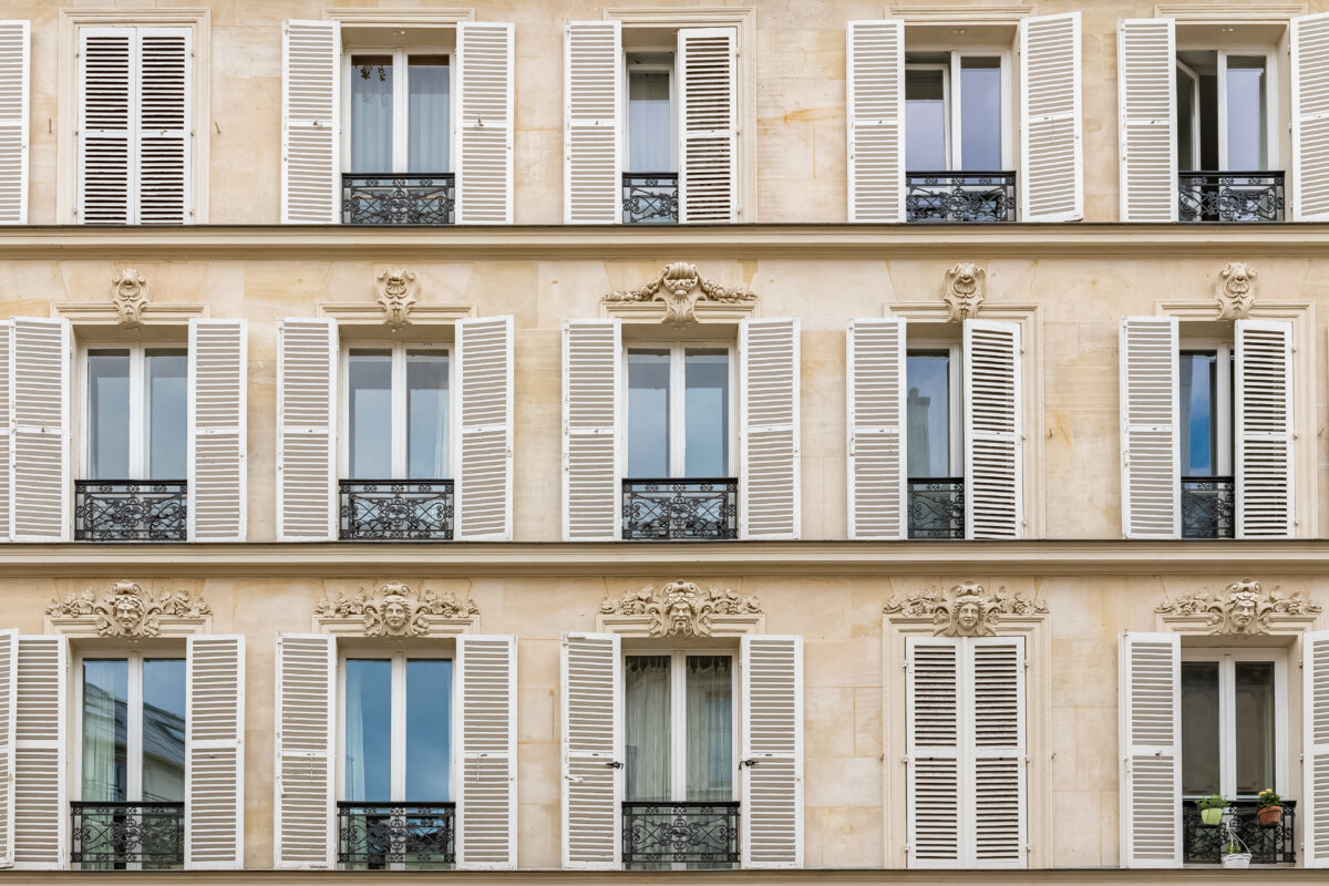 Paris, typical facade in the Marais, detail of the windows