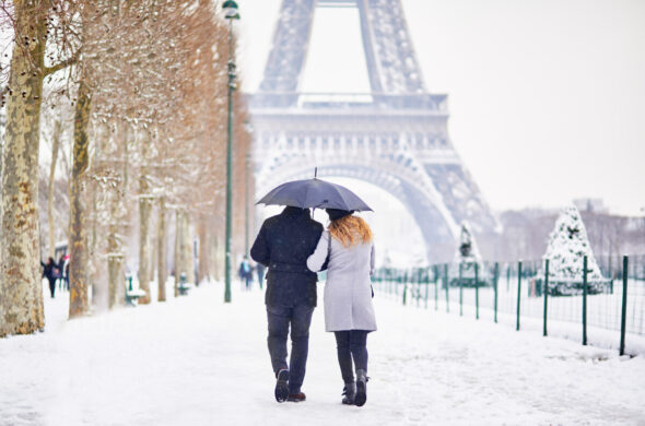 Couple exploring Paris during the winter wearing fashionable winter clothes