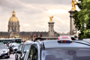 Parisian taxi sign on top of a Taxi vehicle in Paris, France