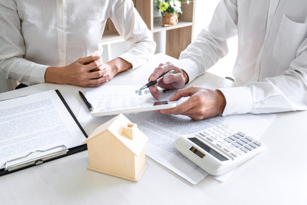 Real estate broker agent presenting documents to a customer