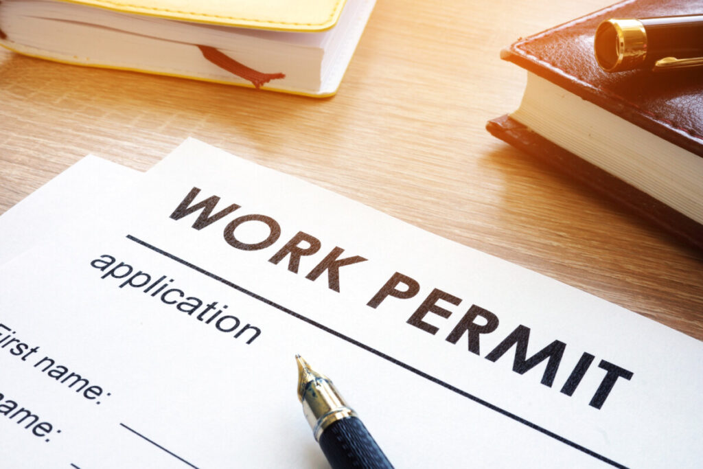 Work permit application form on a wooden table